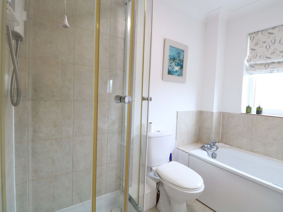A bathroom with a shower, toilet, and bathtub at Old Summer in Northrepps near Cromer