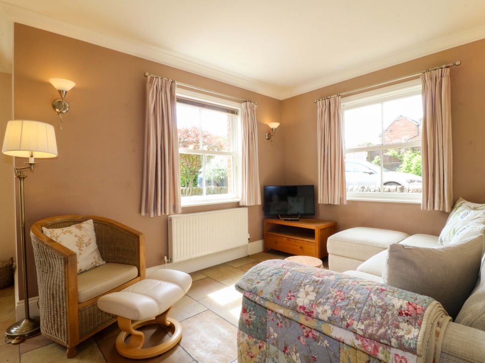 A living room with a sofa and television at The Garden House in Alton
