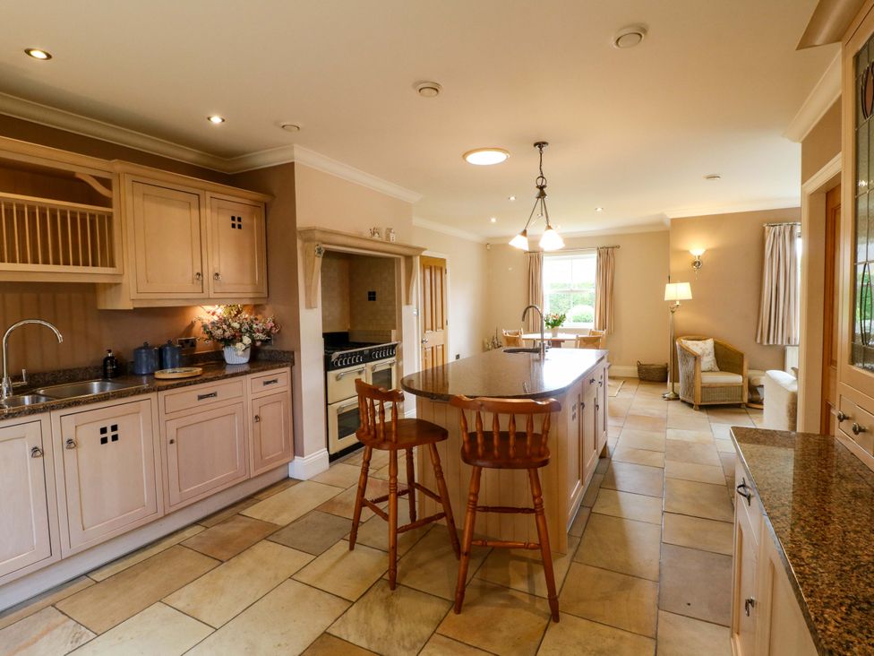 A kitchen with cabinets, sink, and appliances at The Garden House in Alton