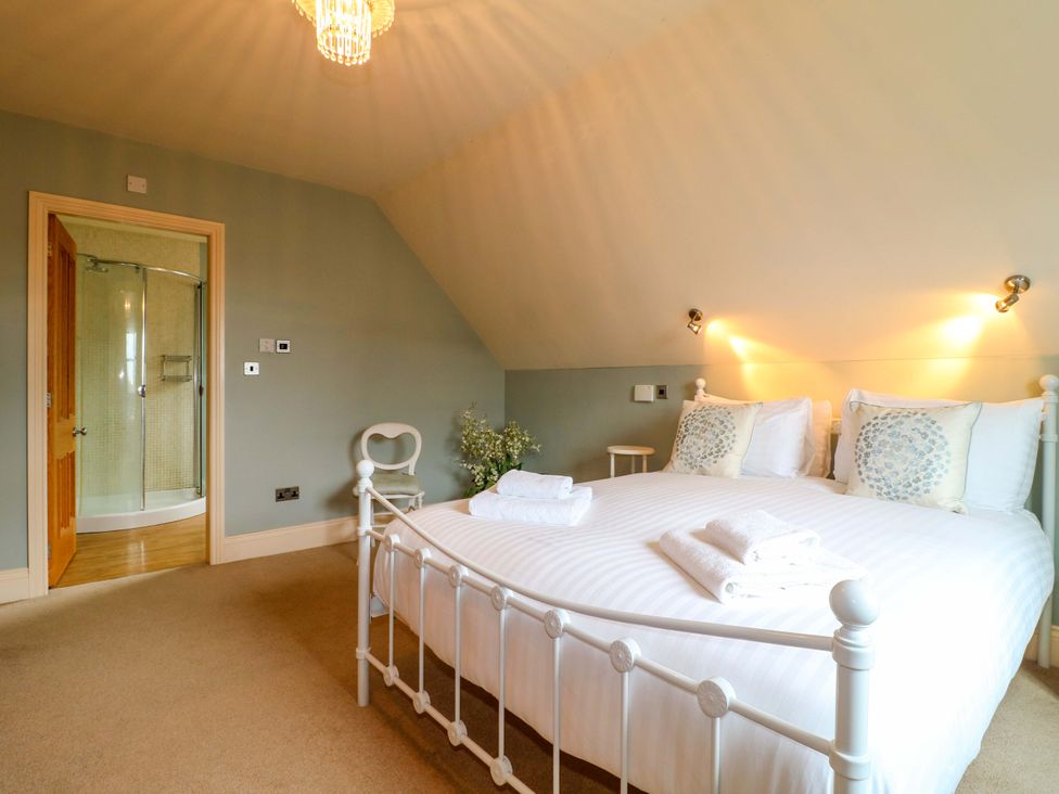 A bedroom with a double bed and en suite shower at The Garden House in Alton