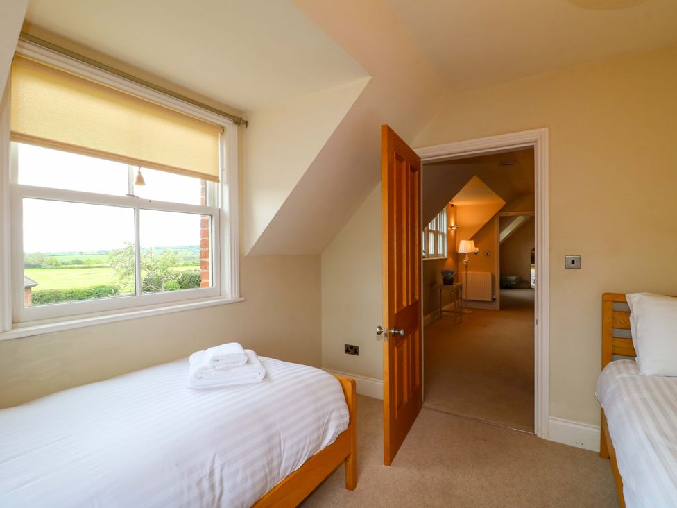 A bedroom with two beds and a window at The Garden House in Alton