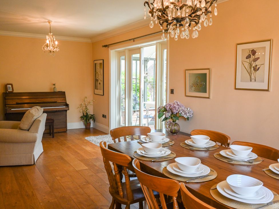 A dining room with a table set for dinner at The Garden House in Alton