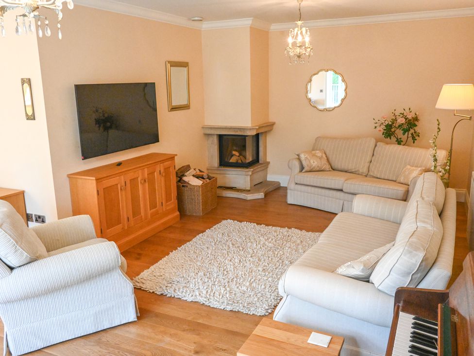 A living room with a sofa and television at The Garden House in Alton