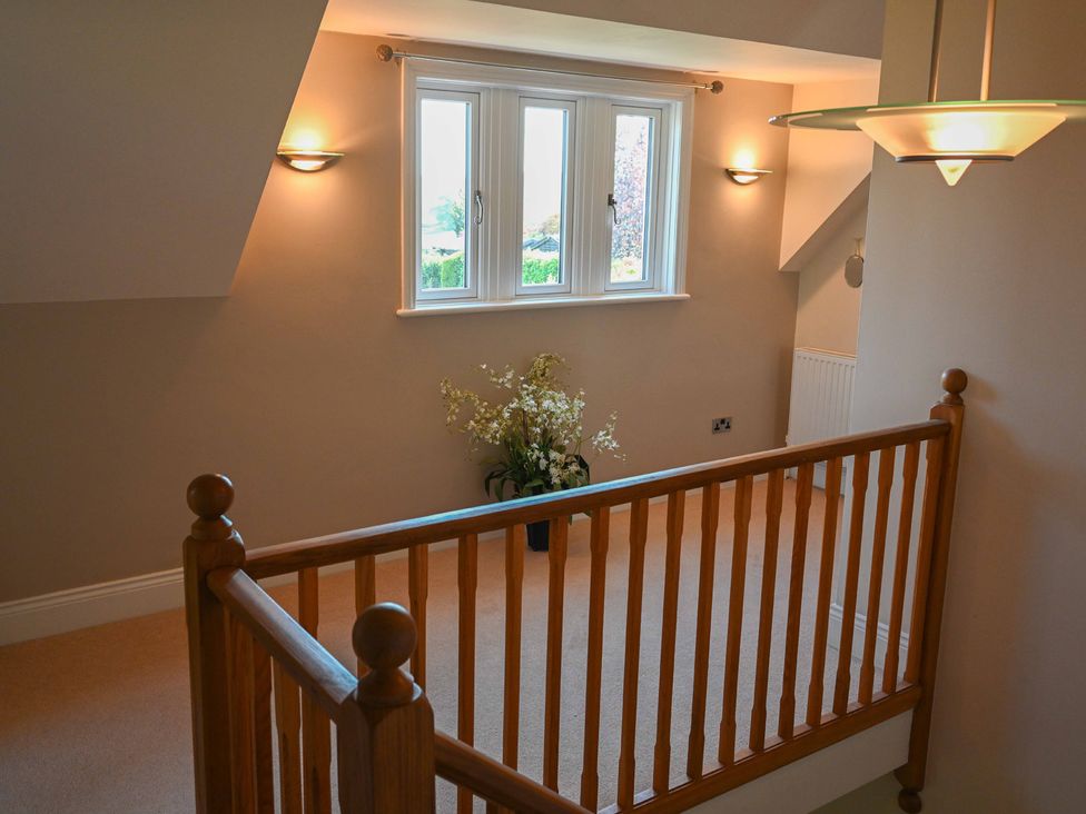 A landing with a window and a flower arrangement at The Garden House in Alton