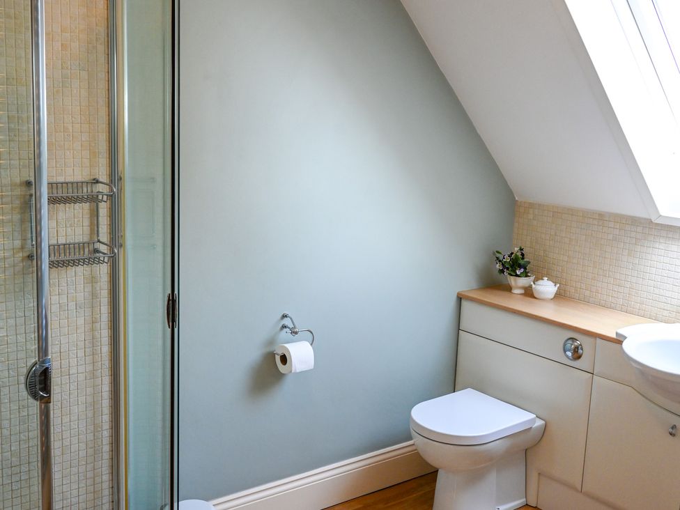 A bathroom with shower, toilet, and sink at The Garden House in Alton