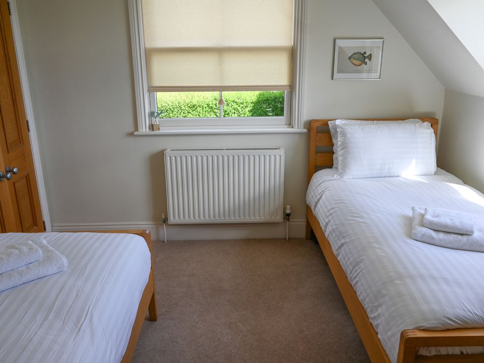 A bedroom with two beds and a window at The Garden House in Alton