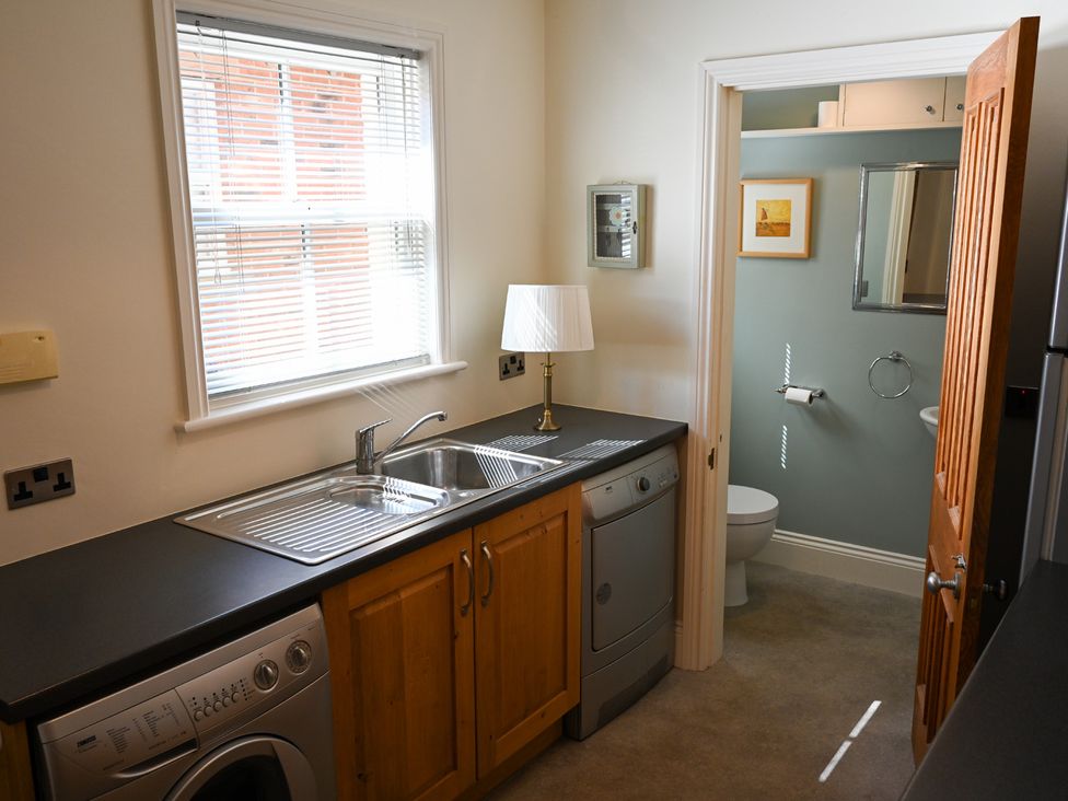 A kitchen with a sink and dishwasher at The Garden House in Alton