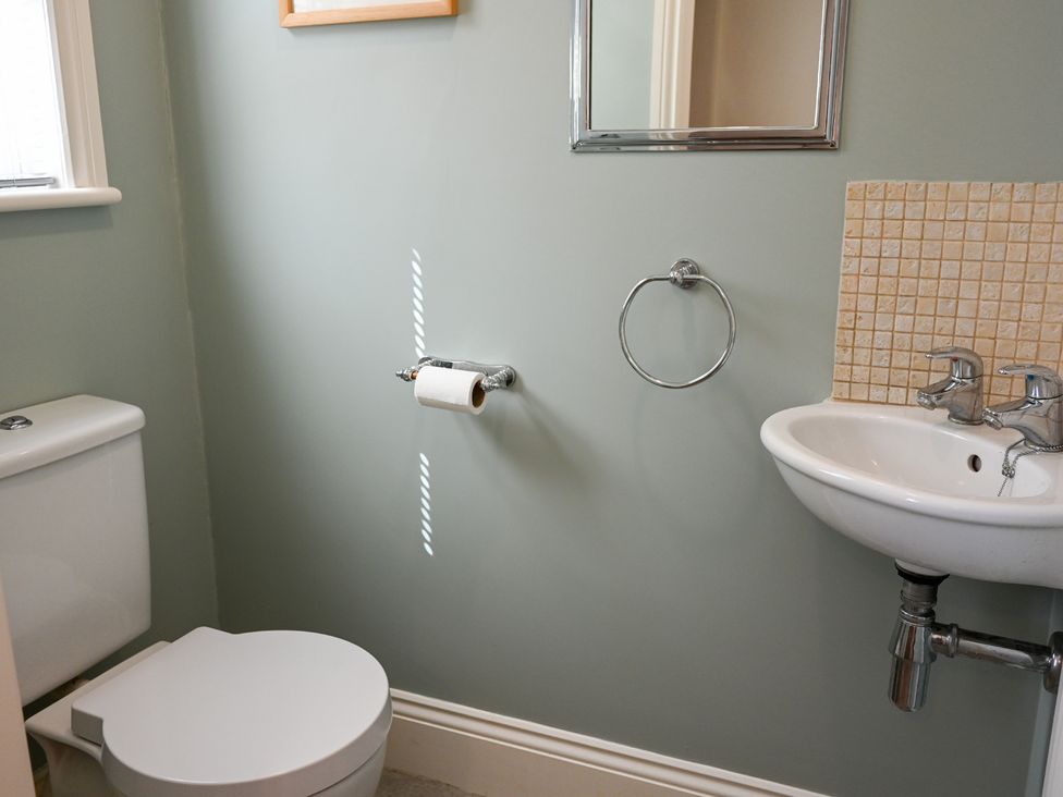 A bathroom with a toilet and washbasin at The Garden House in Alton