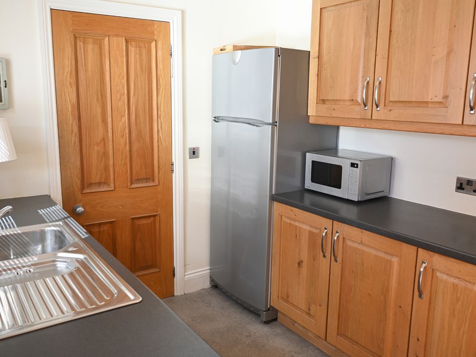 A kitchen with a refrigerator and microwave at The Garden House in Alton