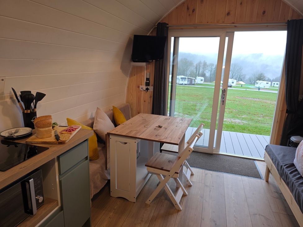 A living room with a table and chairs at Bracelands - Deluxe Pod 9 in Coleford