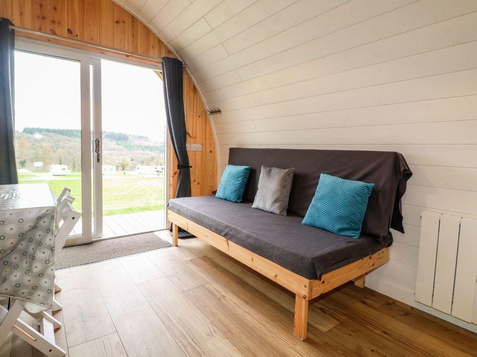 A living room with a sofa and table at Bracelands - Deluxe Pod 9 near Coleford
