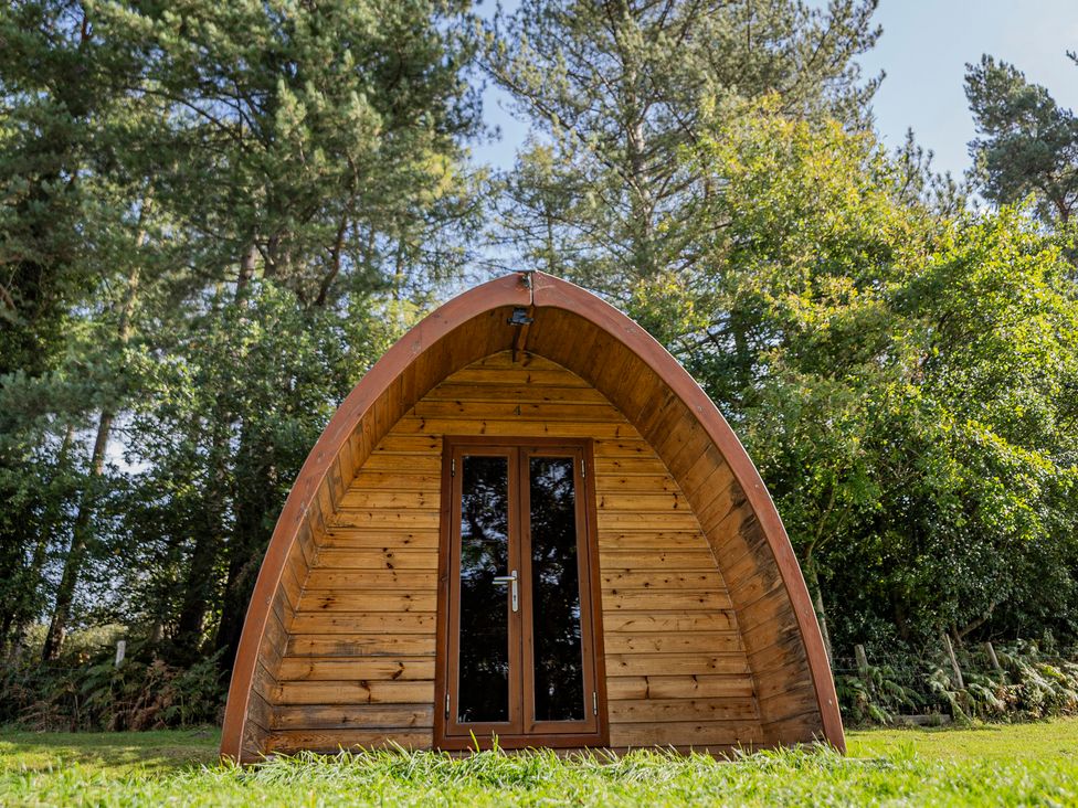 A wooden pod structure surrounded by trees at Bracelands - Deluxe Pod 10 in Coleford