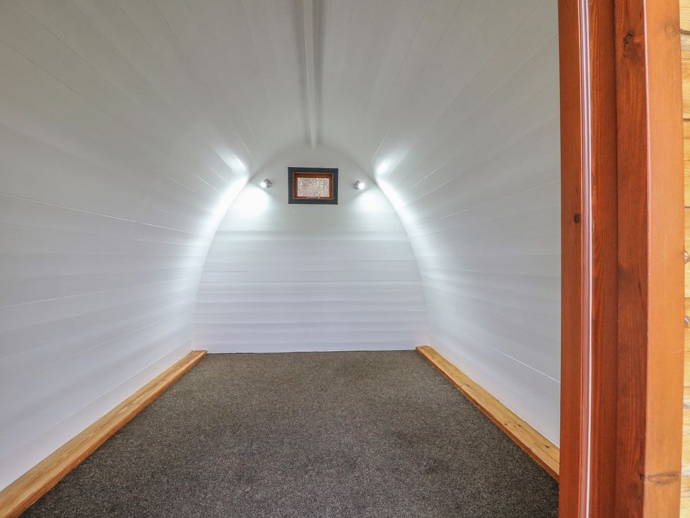 An empty space with white walls and lights at Bracelands - Cosy Pod 1 in Coleford