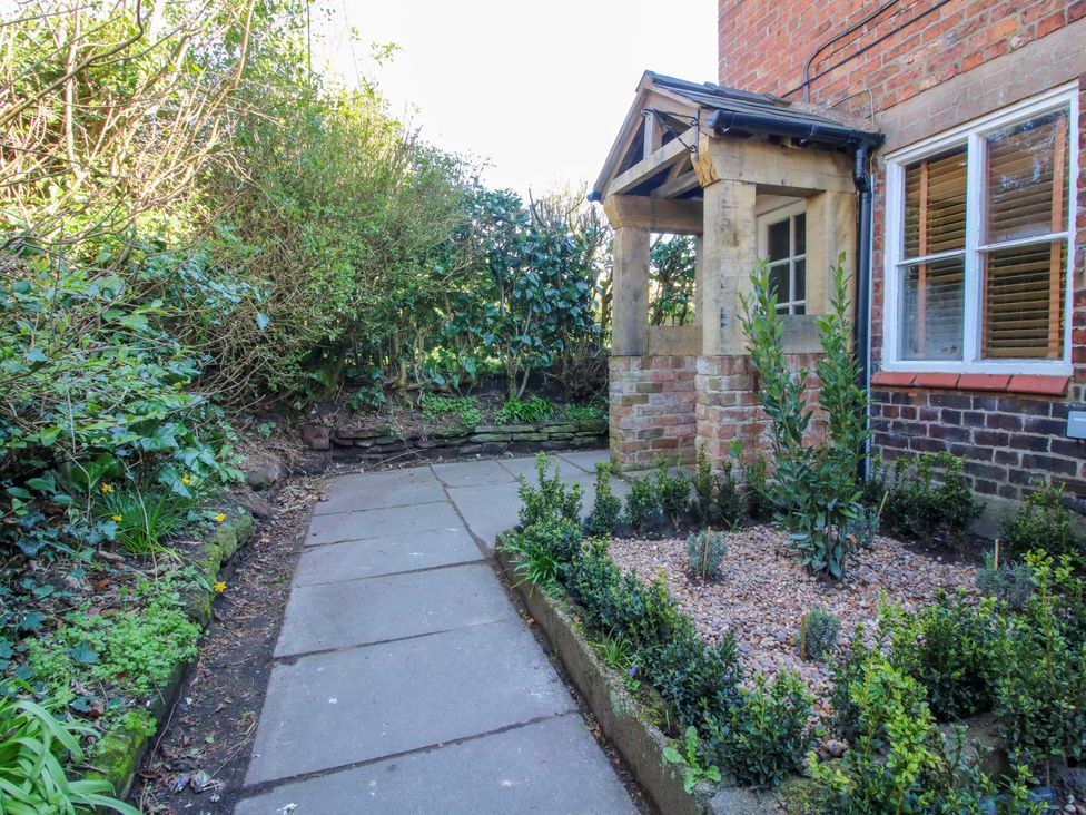 A garden pathway leading to an entrance at Cheshire Views in Malpas