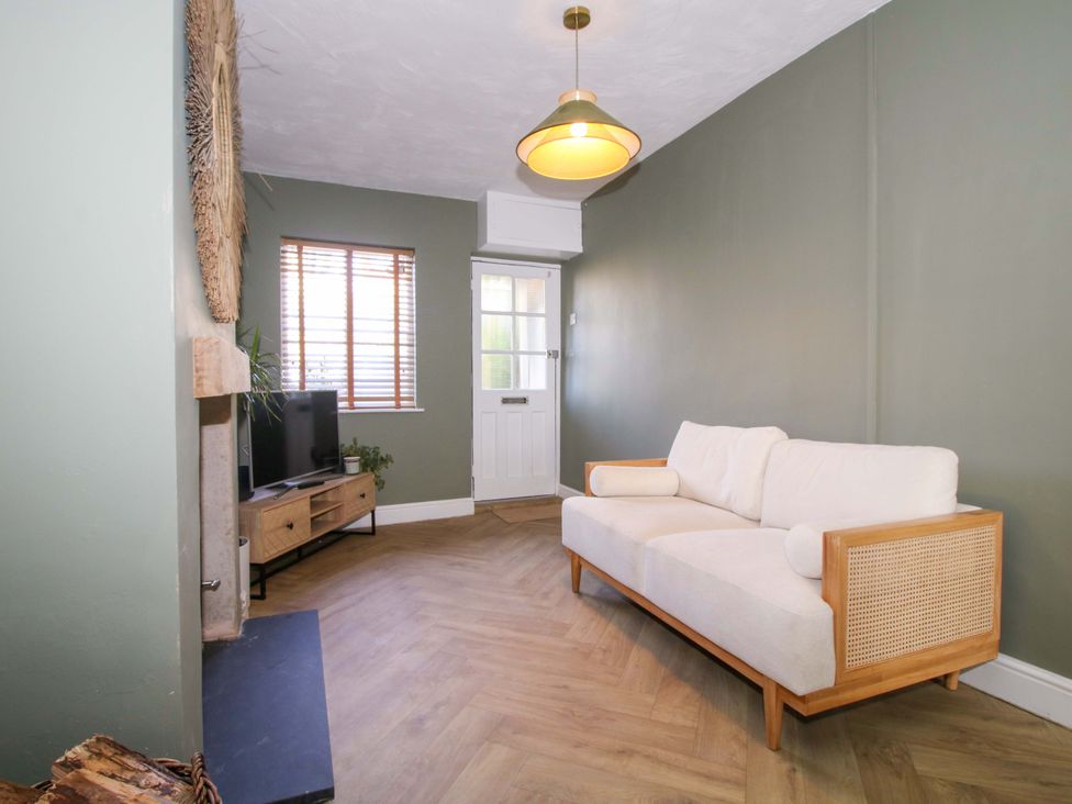 A living room with a sofa and television at Cheshire Views in Malpas