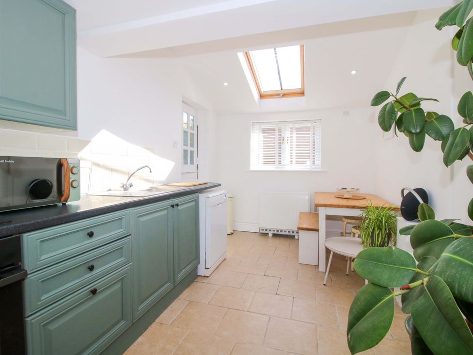 A kitchen with a microwave and table at Cheshire Views in Malpas