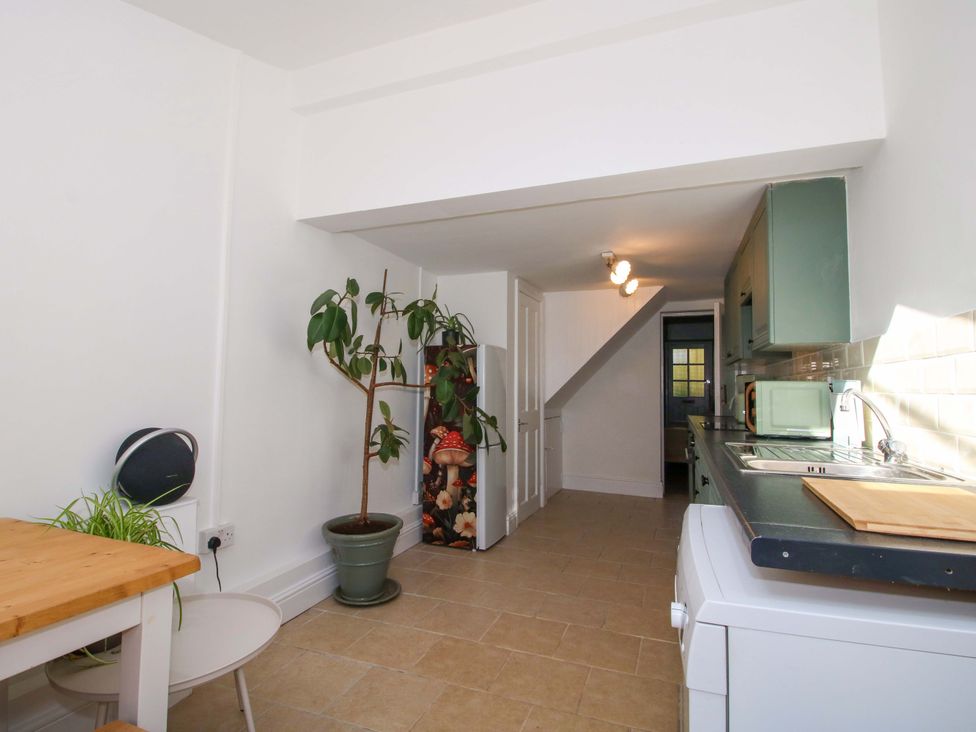 A kitchen with a table and plant at Cheshire Views in Malpas