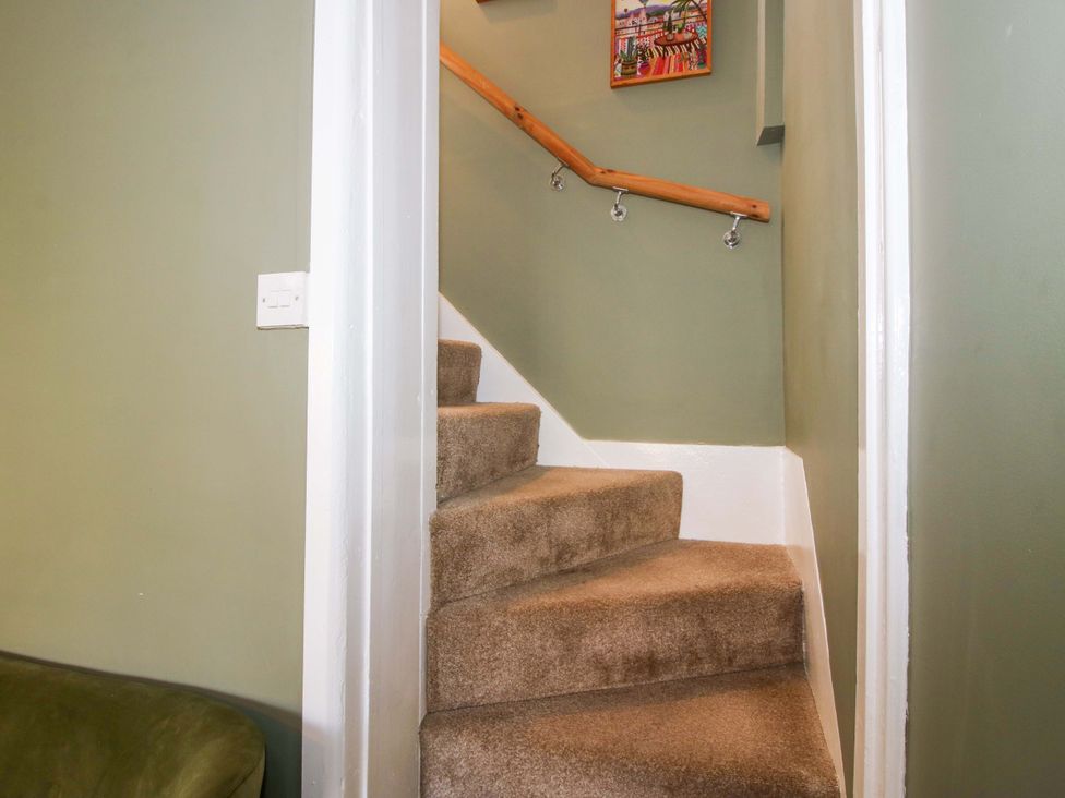A staircase with carpet and handrail at Cheshire Views in Malpas