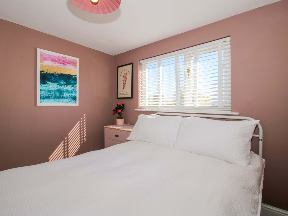 A bedroom with a bed and artworks on the walls at Cheshire Views in Malpas