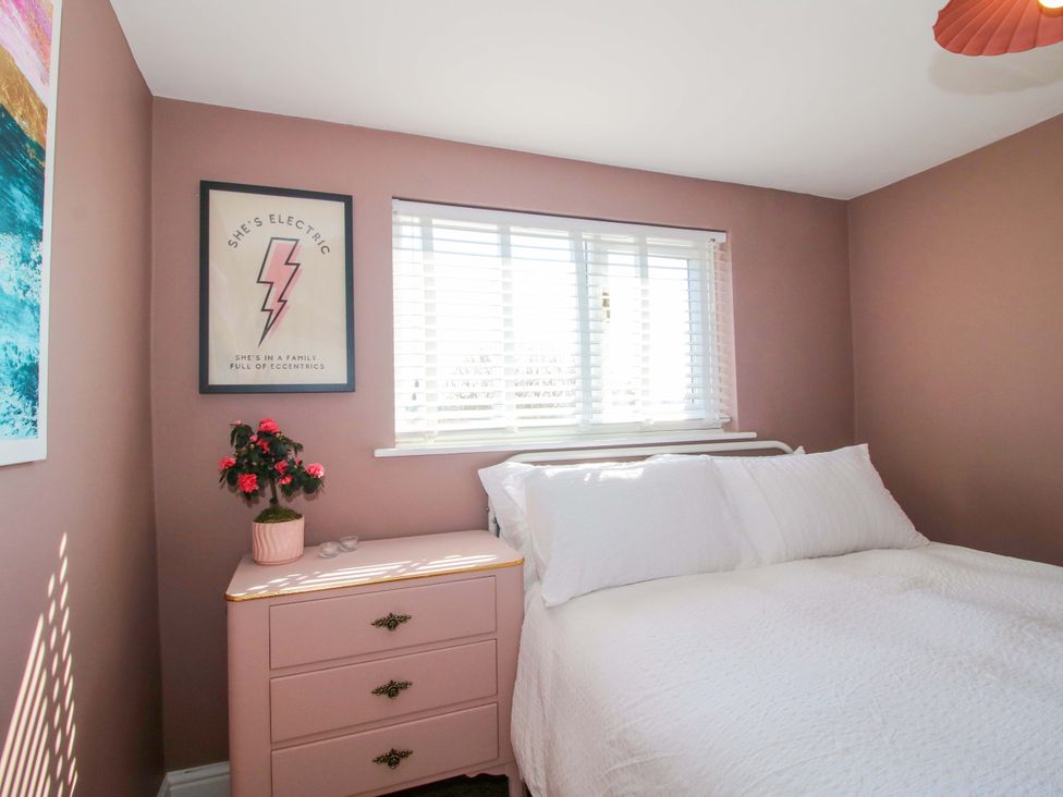 A bedroom with a bed and a nightstand at Cheshire Views in Malpas