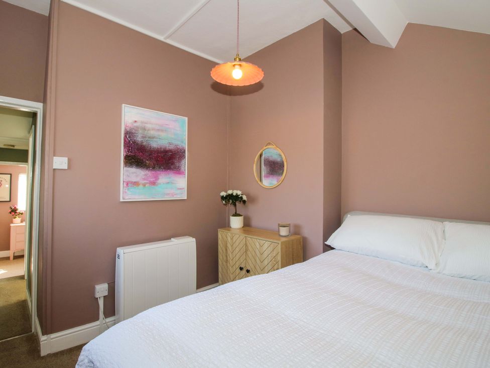 A bedroom with a bed and art on the wall at Cheshire Views in Malpas