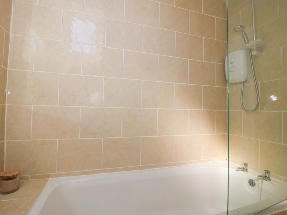 A bathroom with a bathtub and shower at Cheshire Views Malpas