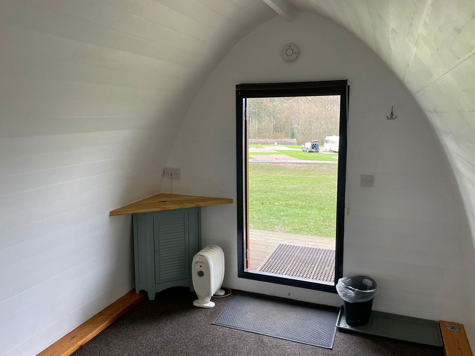 An indoor space with a table and storage cabinet at Bracelands - Cosy Pod 2 Coleford