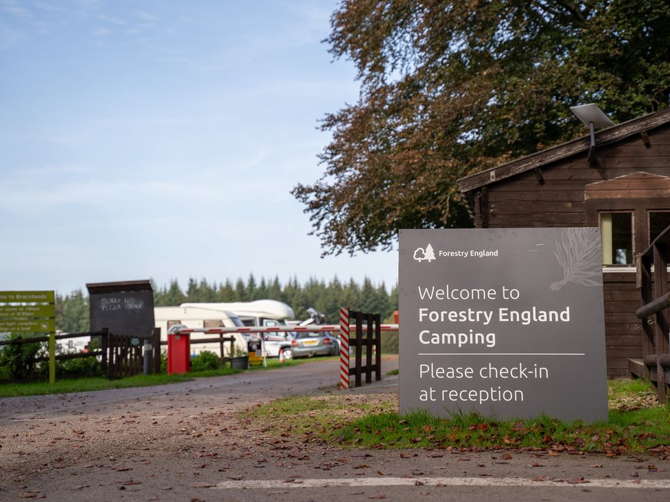 A reception area and welcome sign at Forestry England Camping Bracelands - Cosy Pod 2 Coleford