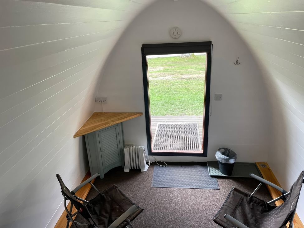 An indoor area with chairs and a table at Bracelands - Cosy Pod 5 in Coleford