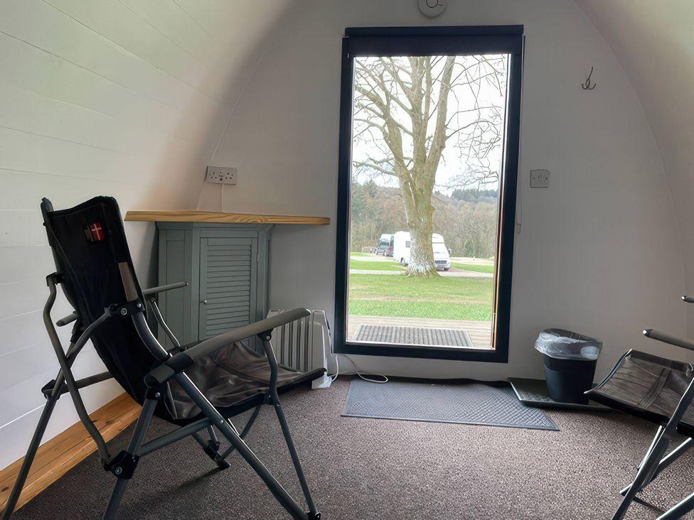 A seating area with chairs and a table at Bracelands - Cosy Pod 5 in Coleford