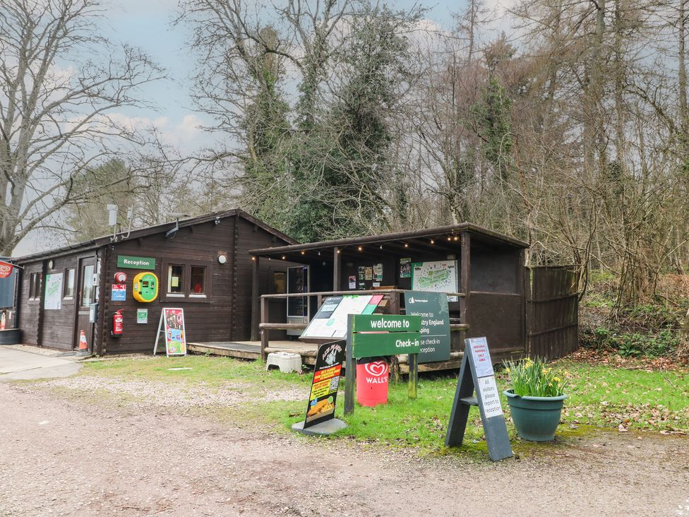 A reception area with signage and a plant pot at Bracelands - Safari Tent 2 in Coleford