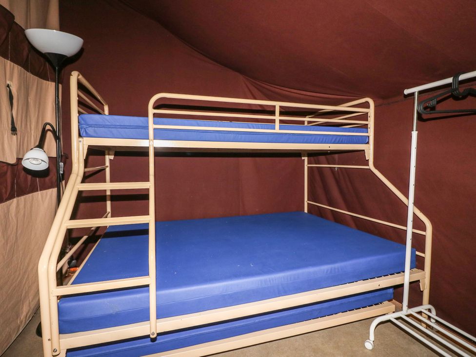 A bunk bed with blue mattresses at Bracelands - Safari Tent 2 near Coleford