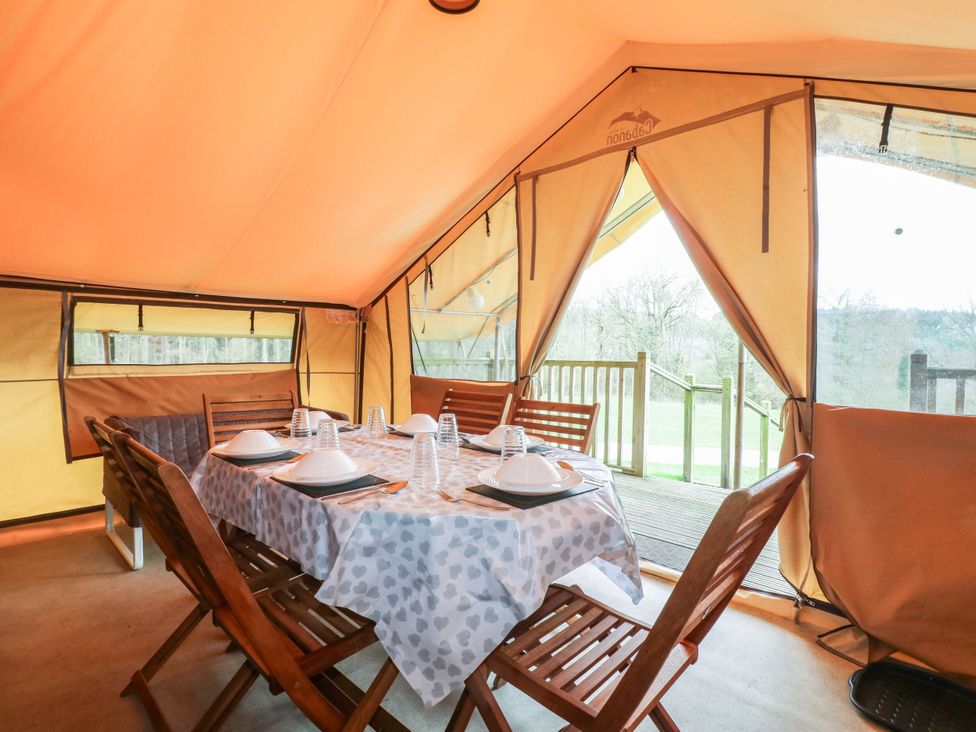 A dining area with a table and chairs in Bracelands - Safari Tent 4 near Coleford