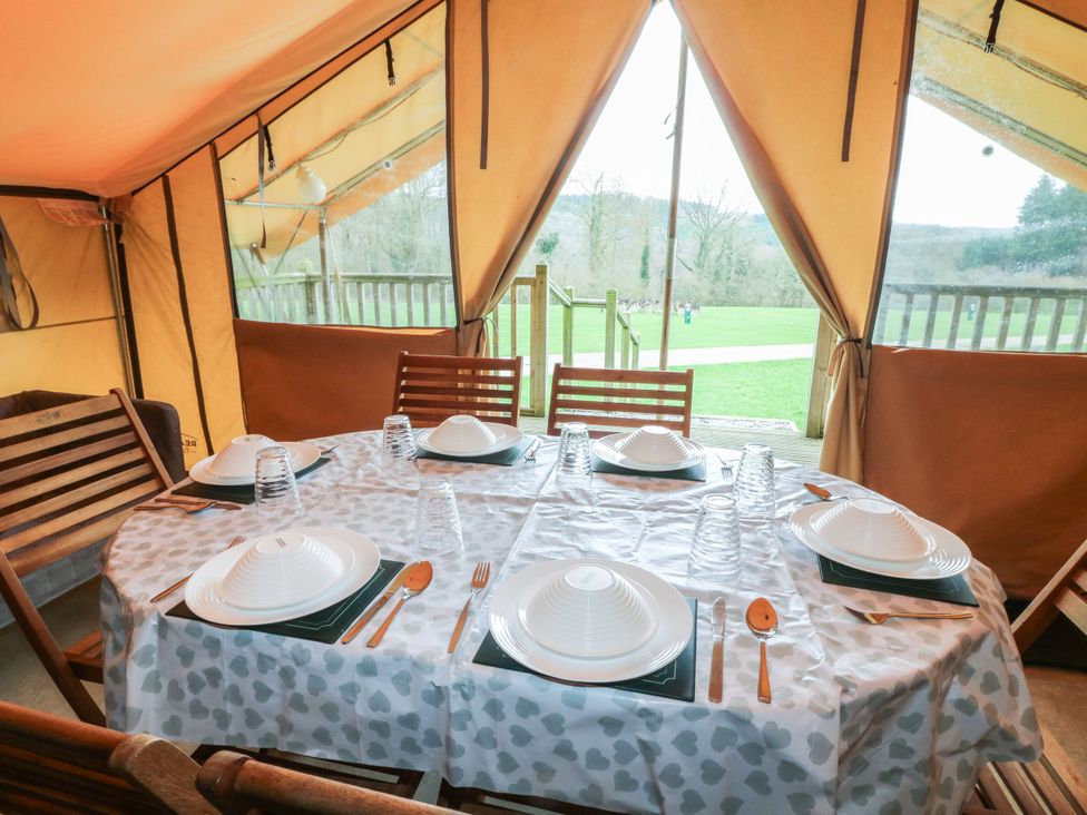 A dining area with table set for meals at Bracelands - Safari Tent 4 near Coleford