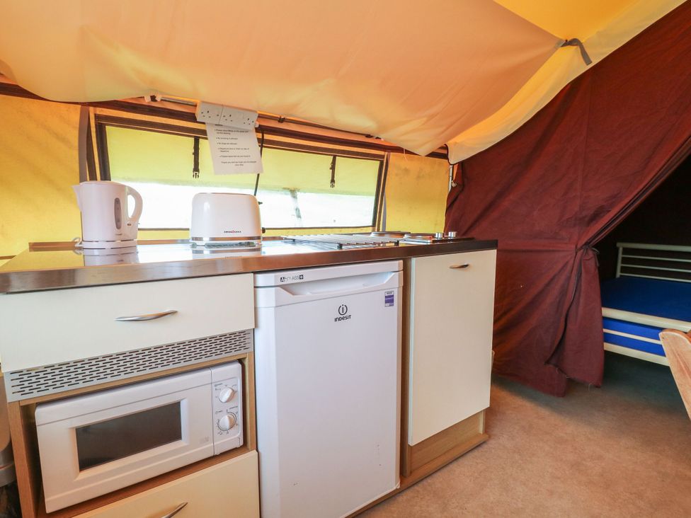 A kitchen area with appliances at Bracelands - Safari Tent 4 near Coleford