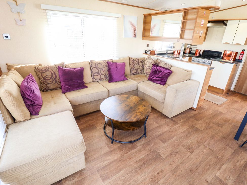 A living room with a sofa and coffee table at Loopy’s Place - PG178 Chapel St Leonards