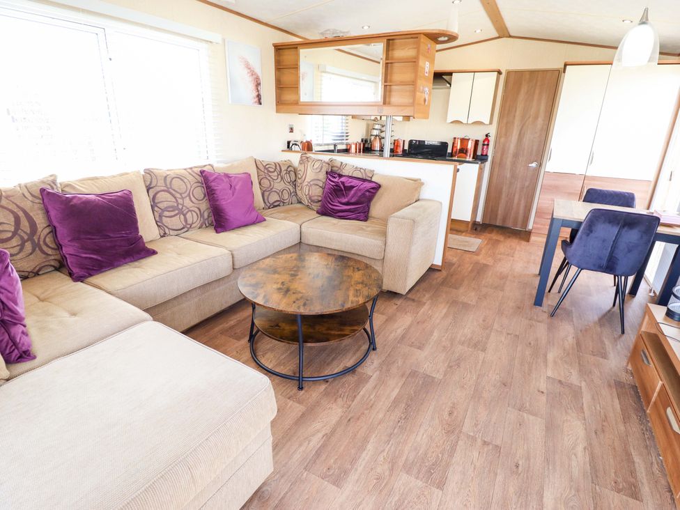 A living room with a couch and coffee table at Loopy’s Place - PG178, Chapel St Leonards