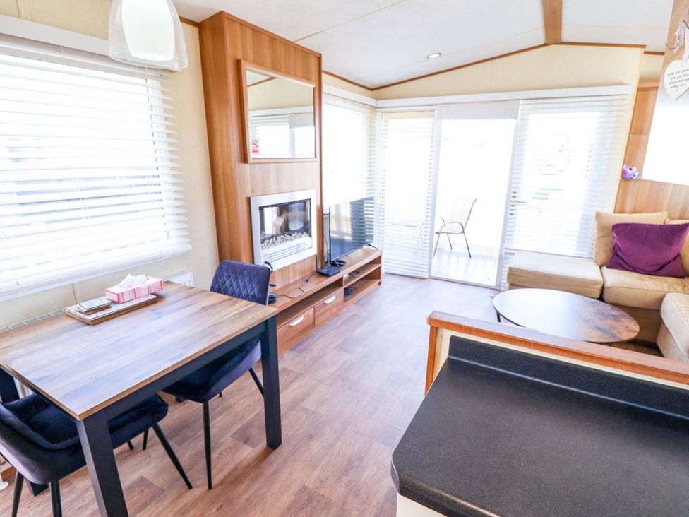 A living room with a dining area and sofa at Loopy’s Place - PG178 in Chapel St Leonards