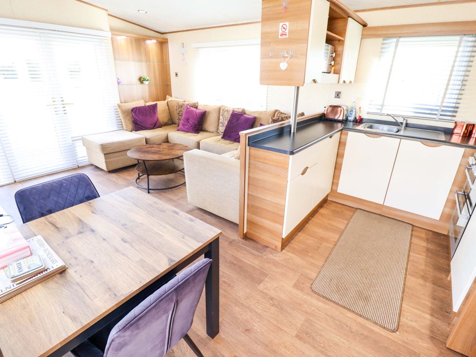 A living room with a sofa and table at Loopy’s Place - PG178 Chapel St Leonards