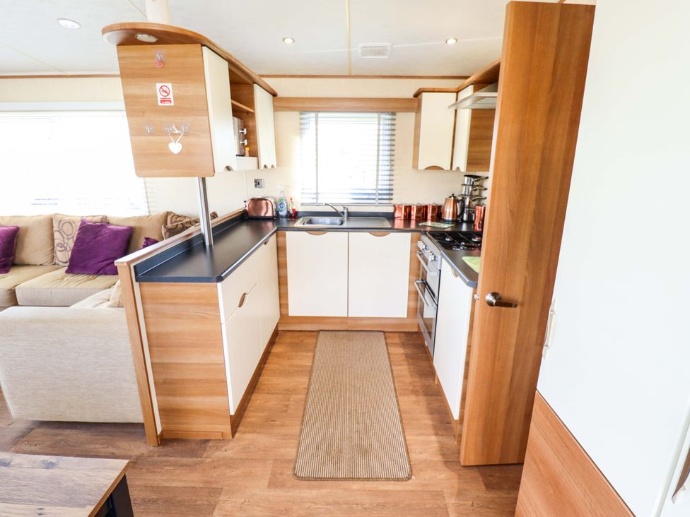 A kitchen with a sink and stove at Loopy’s Place - PG178 Chapel St Leonards