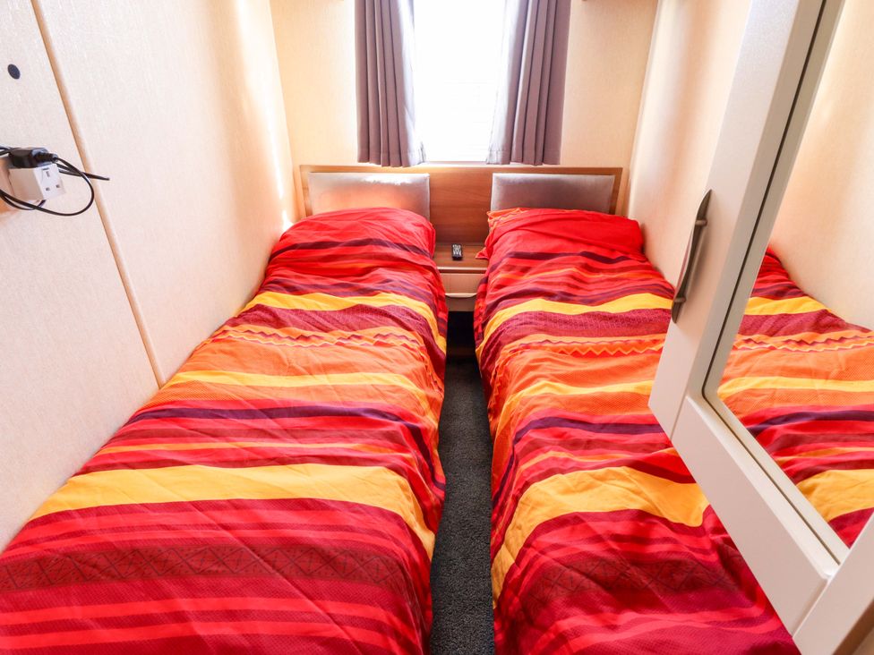 A bedroom with two single beds at Loopy’s Place - PG178, Chapel St Leonards