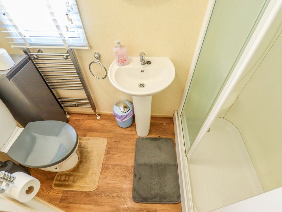 A bathroom with a sink, toilet, and shower at Loopy’s Place - PG178 Chapel St Leonards