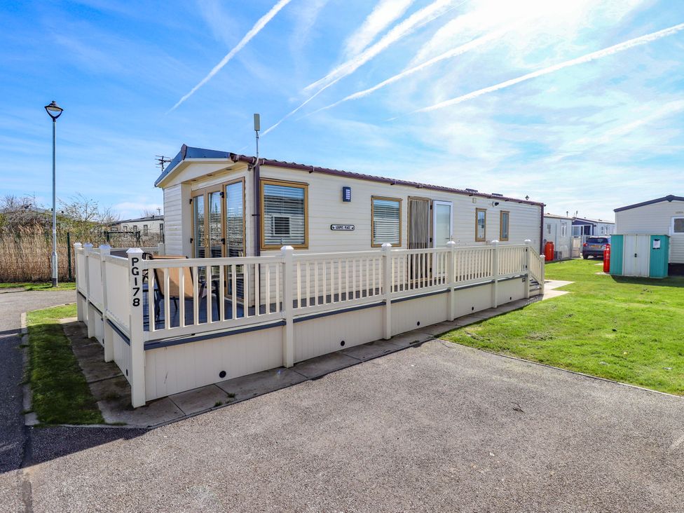 A caravan with a porch and steps at Loopy’s Place - PG178, Chapel St Leonards