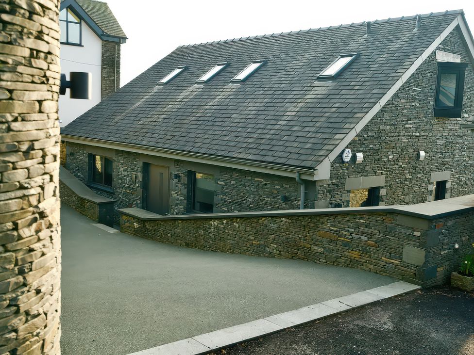 A house with a stone exterior and pathway at Midways in Windermere