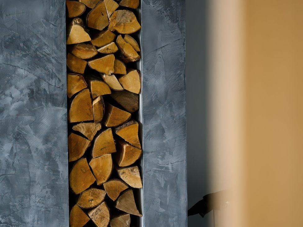 A storage space filled with wood logs at Midways in Bowness-On-Windermere