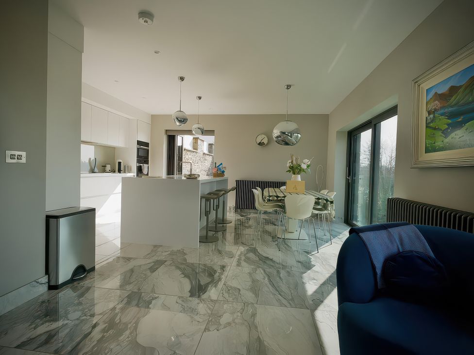 A kitchen with a table and chairs at Midways in Bowness-On-Windermere