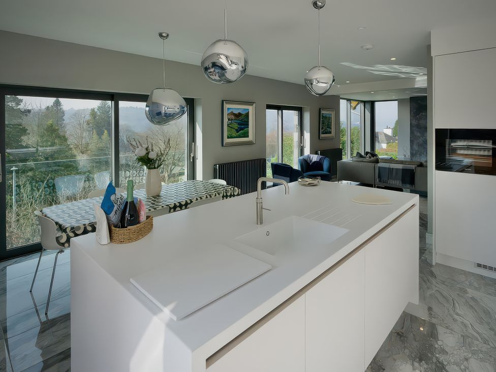 A kitchen with island sink and dining area at Midways in Bowness-On-Windermere