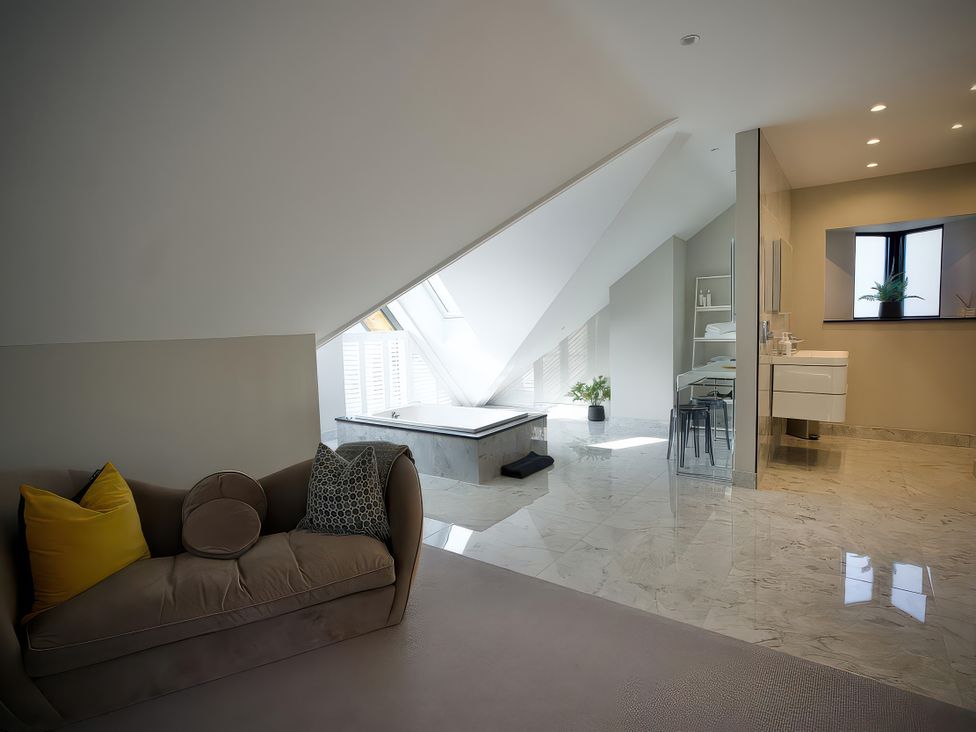 A bathroom with a bathtub and vanity unit at Midways in Bowness-On-Windermere