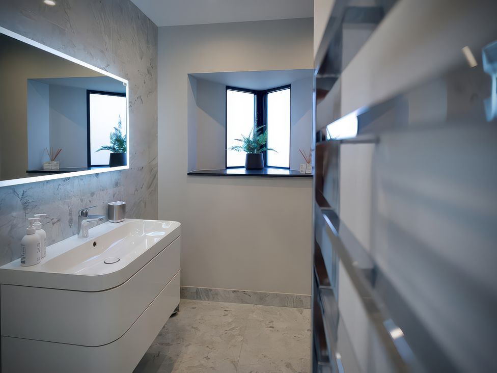 A bathroom with a sink and a window at Midways in Bowness-On-Windermere