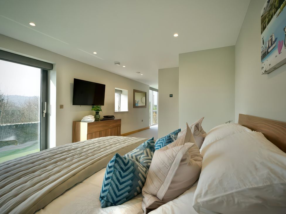 A bedroom with a bed and television at Midways in Bowness-On-Windermere